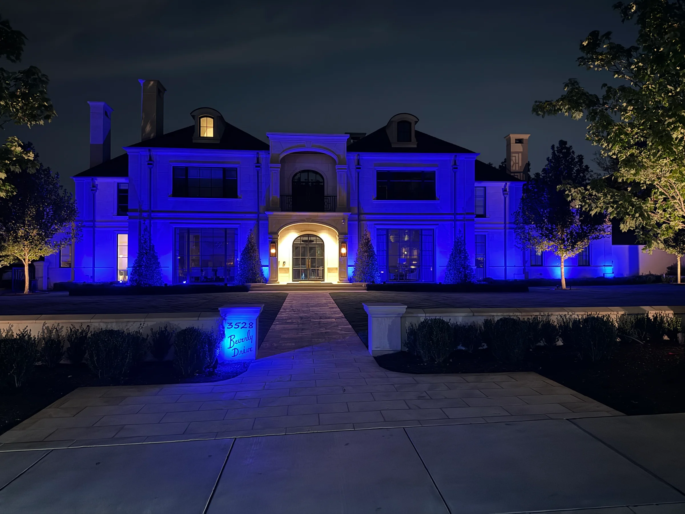 Large home illuminated in coordinated blue zones